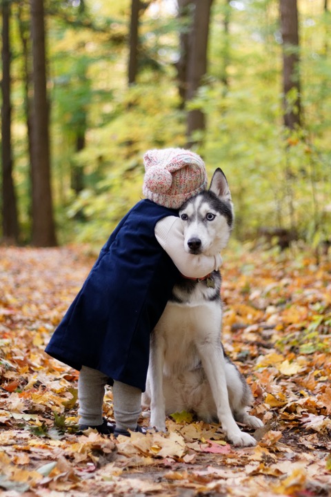 Girl hugging dog showing self-compassion