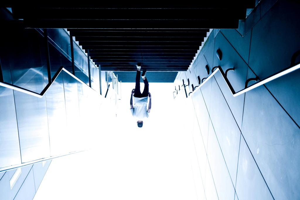 Man walking upstairs upside down