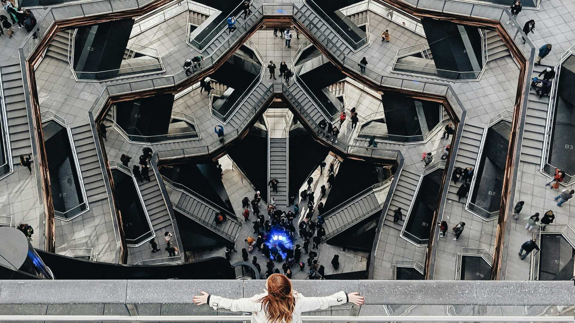 Woman overlooking maze of staircases